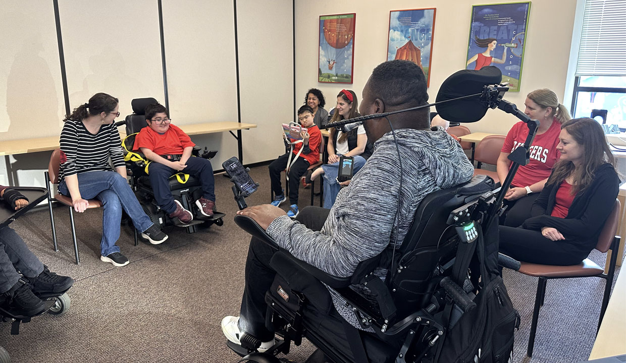 Eric LeGrand speaking with P.G. Chambers School students