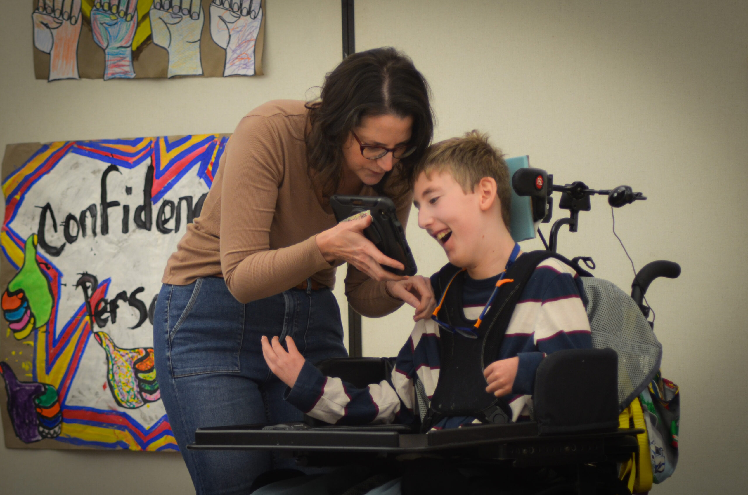 P.G. Chambers School male preschool student smiling and playing in an outdoor water table.